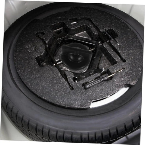 Top view of spare tire in trunk secured by Spare Tire Bolt Hold Down Clamp For Easy Install Wheel Retainer Keeps Spare Tire Secure And Quiet In Trunk Heavy Duty Steel Construction Rust Resistant Car Accessory