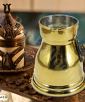 Hand Hammered Brass Copper Ibrik Coffee Pot For Turkish Greek Coffee Maker With Wooden Handle 140 Ml No 3 4.73 Oz Solid Brass Decanter Cezve Jezve Turka Style For Your Daily Brew displayed on a tabletop with surrounding decor.