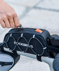 Ride Ready Front Frame Bag For Bikes With Large Capacity Main Compartment attached to bike with hand accessing zipper