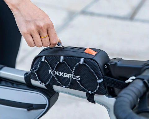 Ride Ready Front Frame Bag For Bikes With Large Capacity Main Compartment attached to bike with hand accessing zipper