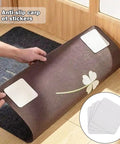 Hands using Non Slip Rug Pad Grippers For Hardwood And Tile, Double Sided Rug Tape with corner stickers on a brown rug.