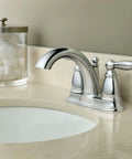 Brantford Chrome Two-Handle Low Arc Centerset Bathroom Faucet With Drain Assembly installed on beige countertop.