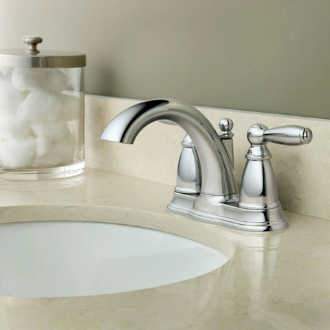 Brantford Chrome Two-Handle Low Arc Centerset Bathroom Faucet With Drain Assembly installed on beige countertop.