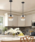 Sage 10 Inch Farmhouse Pendant Light With Hammered Glass And Natural Rope Accent hung over a kitchen island