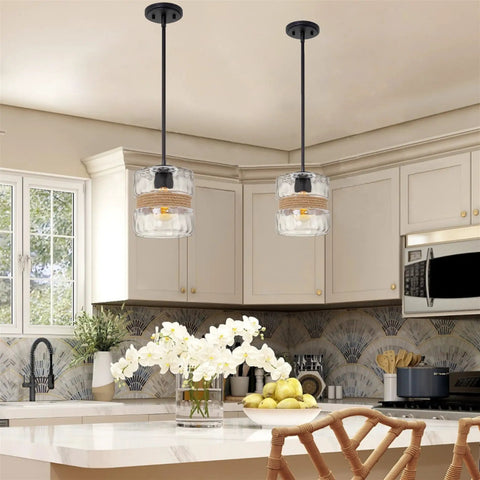 Sage 10 Inch Farmhouse Pendant Light With Hammered Glass And Natural Rope Accent hung over a kitchen island