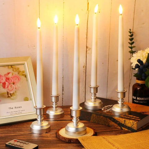 24 Pack Flameless Taper Candles With Remote And Timer, Flickering 3D Flame LED Tapers in silver bases on a wooden table