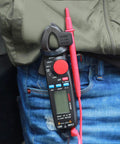 Person holding Mini Clamp Meter For AC And DC Current Up To 100 Amp, Auto Range Digital Multimeter with Frequency Tester