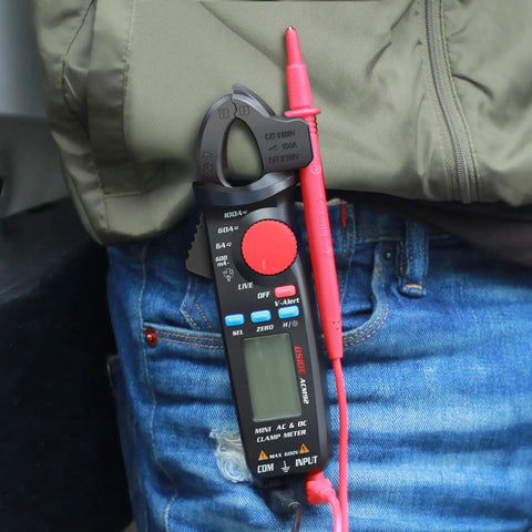 Person holding Mini Clamp Meter For AC And DC Current Up To 100 Amp, Auto Range Digital Multimeter with Frequency Tester