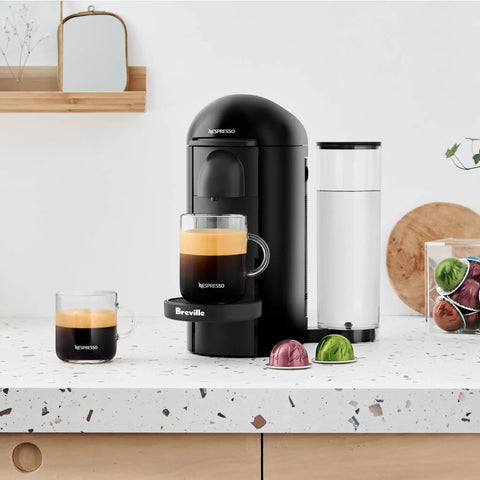 Vertuo Plus Single Serve Coffee And Espresso Maker By Breville In Ink Black With 25 Second Heat Up And Auto Shut Off For Quick One Touch Brews And Rich Flavor Every Morning on a kitchen counter