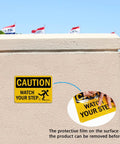 Kickass Caution Watch Your Step Signs 2 Pack 10 X 7 Inch Rust Free Reflective Aluminum Safety Plaque on wall outdoors.