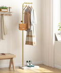 Gold Metal Coat Rack With 3 Hooks, L Shaped Freestanding Coat Tree For Entryway Or Corner in a room with clothes and bag