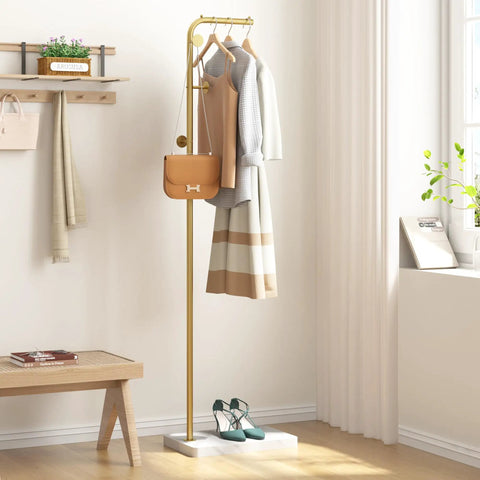 Gold Metal Coat Rack With 3 Hooks, L Shaped Freestanding Coat Tree For Entryway Or Corner in a room with clothes and bag