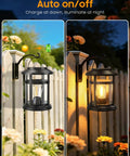 2 Pack Solar Lanterns Outdoor Waterproof Hanging Lights for Garden Patio Porch Decor, warm white LED, shining at night on a fence