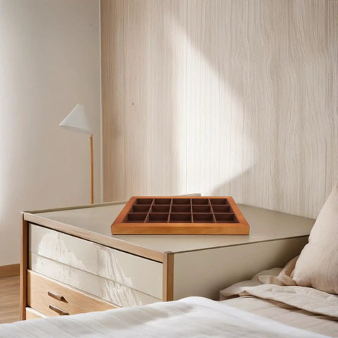 Top Shelf Solid Walnut Wood Jewelry Tray Organizer With Fifteen Grids For Rings Necklaces And Bracelets Compact Vanity Storage Display Plate For Counters on a bedside table.