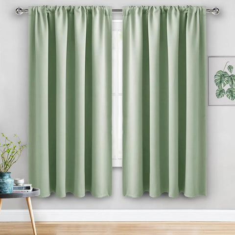 Extra Wide 70x63 Inch Blackout Curtains Set Of 2 Panels With Tiebacks Rod Pocket Thermal Insulated Room Darkening Drapes For Bedroom And Sliding Doors Light Green Color No Fuss Install Privacy And Light Control hanging in a room with a window