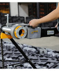 Hands operating Badass Heavy Duty Electric Pipe Cutter And 2 Inch Tube Expander With Die Head Threading Machine for metal cutting.