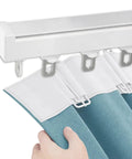 Heavy Duty Silent Sliding Barn Door Track Kit With Quality Rollers mounted with blue curtain for easy sliding in living spaces.