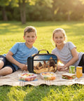 Two children having a picnic with Camel Desert Insulated Lunch Box With Detachable Handle For Women And Men on a blanket.
