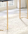 Adjustable Standing Computer Desk With Built Storage And Power Port, Sleek Faux Marble Work Table For Home Office, Gold Metal Frame legs on plush white rug.