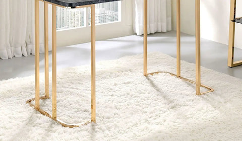 Adjustable Standing Computer Desk With Built Storage And Power Port, Sleek Faux Marble Work Table For Home Office, Gold Metal Frame legs on plush white rug.