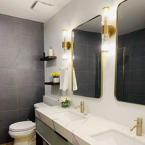 Golden Glass Shade Wall Sconce Lighting For Bathroom Vanity, Modern Gold Finish, mounted beside bath mirror in elegant setting.