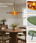 Amber Glass Pendant Light Modern: 19-inch Metal Chandeliers For Dining Room over a wooden table with vase and greenery.