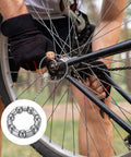 Person installing Bicycle Crank Ball Bearings Kit 3/16 Inch 5mm 7 Balls 10 Pack Replacement Bearings on a bike wheel