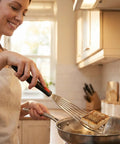 Fish spatula, 10.3-inch stainless steel slotted turner with silicone handle, shown flipping fish in a skillet.