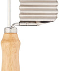 Vegetable crinkle cutter and French fry slicer with wooden handle and ribbed stainless steel blade.