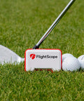 Mevo Portable Golf Launch Monitor And Rangefinder With Signature Gift Bundle on grass with golf balls and club