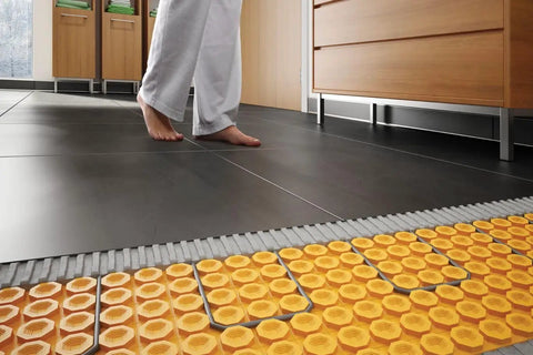 Person standing on heated tile floor with Ditra Heat EHK Electric Floor Heating Cable Kit underneath, 240V, 35.3 feet.