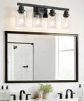Top Shelf 4 Light Bathroom Vanity Light With Clear Glass Sleeves Matte Black Vintage Wall Sconce above mirror and sink.