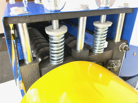 Model 930 Motorized Wire Stripper with dual top and bottom rollers and springs, close-up view
