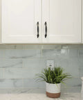 White cabinet with Solid Zinc Alloy Cabinet Pull Handle In Oil Rubbed Bronze, 7 Inch Overall Length, installed in a kitchen.