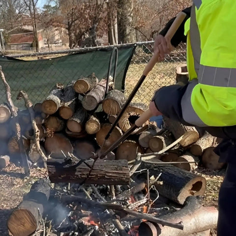 Person using 42 Inch Fire Tongs And Fire Poker Set Beefy Heavy Duty Detachable Log Grabbers for firewood handling outdoors