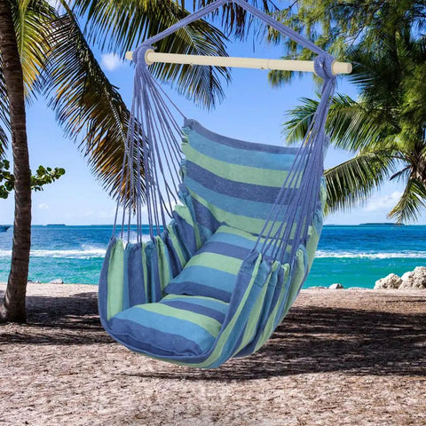 Heavy Duty Hammock Chair Hanging Rope Swing With Steel Spreader Bar For Indoor And Outdoor Relaxation Macrame Seat With Two Cushions Supports Up To 550 Lbs Blue Green Stripe hanging on beach