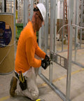 Worker installing Aluminum MC Cable 12/2 100 Ft White Lightweight Armor For Easy Pull, UL Classified Firestop 1, 2, And 3 Hour.