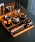 Premium 58mm Bottomless Portafilter With Thick Walnut Handle For Breville Dual Boiler And Oracle Touch Espresso Machines on a wooden tray.