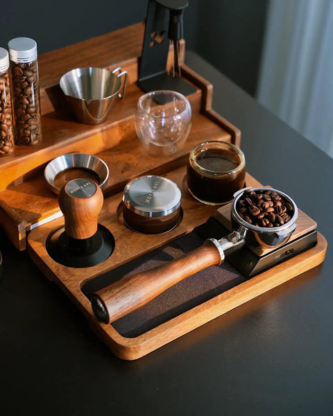 Premium 58mm Bottomless Portafilter With Thick Walnut Handle For Breville Dual Boiler And Oracle Touch Espresso Machines on a wooden tray.