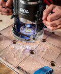 Hands using Spaced Dog Hole Router Template For Precise Holes And Bench Tools Like Dogs Cookies And Holdfasts Non Slip Easy To Align Inlay Jig For Woodworking Projects A Must-Have Tool For Quick Clean Accurate Grids on a workbench