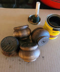 Real Deal Solid Hardwood 2 Inch Round Bun Feet For Furniture Upgrades And DIY Repairs Includes Mounting Plates With Screws Set Of Four unpainted bun feet with wood finish and applicator.