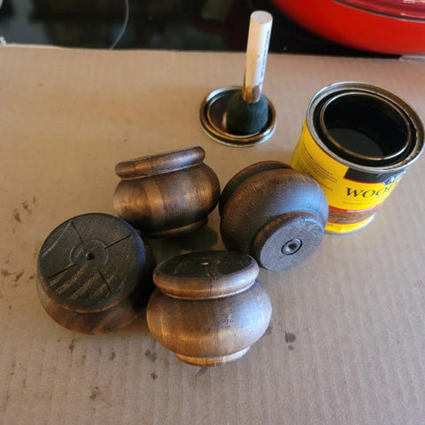Real Deal Solid Hardwood 2 Inch Round Bun Feet For Furniture Upgrades And DIY Repairs Includes Mounting Plates With Screws Set Of Four unpainted bun feet with wood finish and applicator.