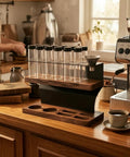Premium Two Tier Coffee Bean Storage Rack With Wooden Base And Twelve Clear Glass Jars Featuring Air Release Vents For Crisp Freshness And Top Shelf Kitchen Counter Organization Straight Fire Setup on kitchen countertop.