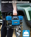 Person holding a 12V dual cylinder air compressor with digital display panel, showing dimensions, near an offroad vehicle.
