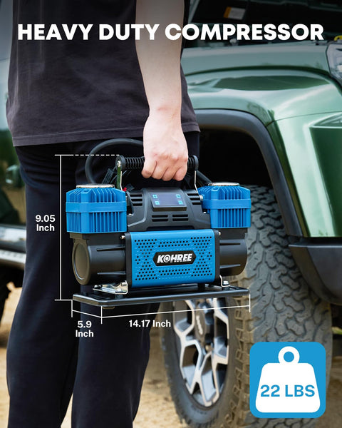 Person holding a 12V dual cylinder air compressor with digital display panel, showing dimensions, near an offroad vehicle.