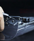 Handheld Single Hole Paper Punch For Scrapbooking And Office Use, shown punching clear plastic film with a metal body