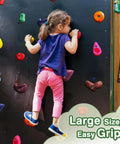 Child climbing on wall using 32 Piece Rock Climbing Holds Set For Kids And Adults, Kid Friendly Colorful Plastic Wall Grips
