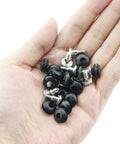 Hand holding 20 Pack Three Point Five Inch Anti Vibration Mounting Screws for PC Hard Drives Black Vibration Damping Screws