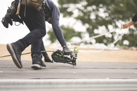 Durable Badass Pneumatic Cap Nailer Built Like Steel For Smashing Roofing Underlayment Sheets With Huge Capacity Magazine and Smooth Bump Fire Trigger Action in use on roof.