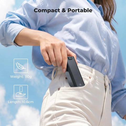 Person placing 5000mAh Fast Charging Battery Handle for Osmo Pocket 3 and 4 Power Grip in pocket, showing portability